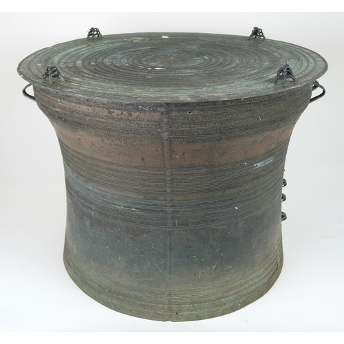 2409 - A LAOTIAN BRONZE RAIN DRUM Of traditional type, with applied animals to top and pierced strap h... 