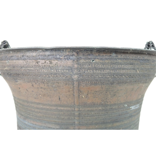 2409 - A LAOTIAN BRONZE RAIN DRUM Of traditional type, with applied animals to top and pierced strap h... 