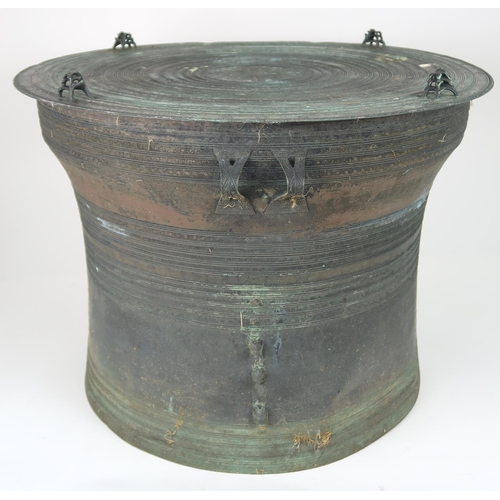 2409 - A LAOTIAN BRONZE RAIN DRUM Of traditional type, with applied animals to top and pierced strap h... 