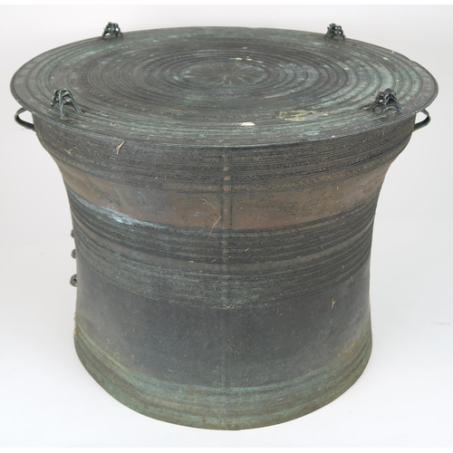 2409 - A LAOTIAN BRONZE RAIN DRUM Of traditional type, with applied animals to top and pierced strap h... 