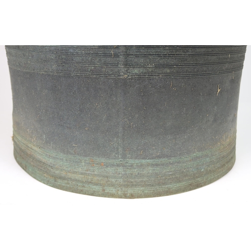 2409 - A LAOTIAN BRONZE RAIN DRUM Of traditional type, with applied animals to top and pierced strap h... 