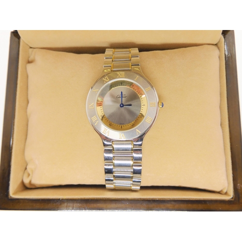 2894 - *WITHDRAWN* A MUST DE CARTIER 21 WATCHwith two tone dial and blued steel hands, jewel set winder and... 