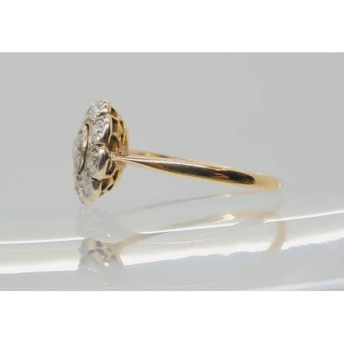 2713 - A DIAMOND FLOWER RINGthe bright yellow metal mount is set with estimated approx 0.40cts, of old cut ... 