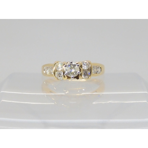 2717 - A 14K GOLD DIAMOND RINGthe central high prong set diamond is estimated approximately at 0.20cts with... 