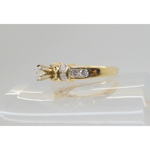 2717 - A 14K GOLD DIAMOND RINGthe central high prong set diamond is estimated approximately at 0.20cts with... 