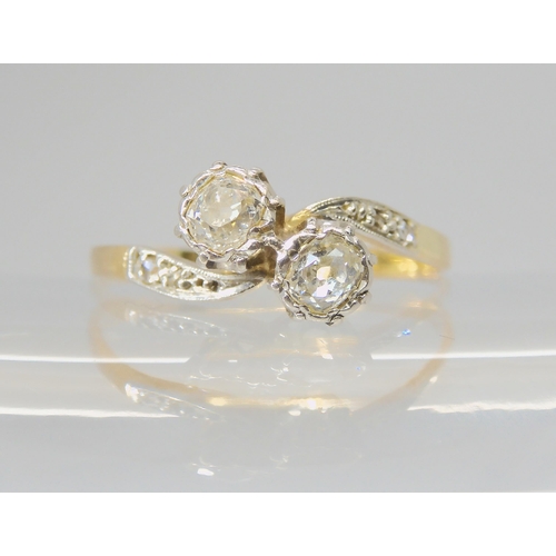 2721 - A TWIN STONE DIAMOND RINGthe bright yellow and white metal mount is set with two old cut diamonds, w... 