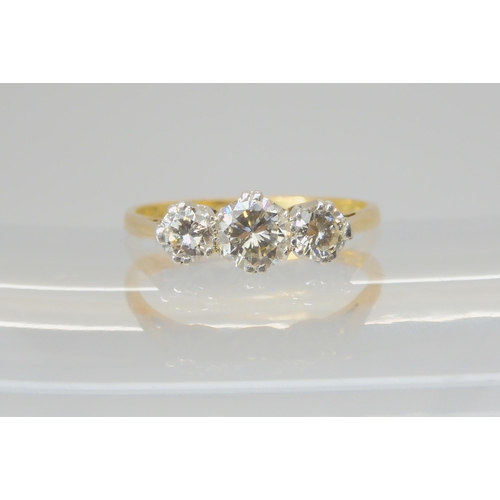 2723 - A THREE STONE DIAMOND RINGmounted throughout in 18ct gold, and set with estimated approx 0.91cts in ... 