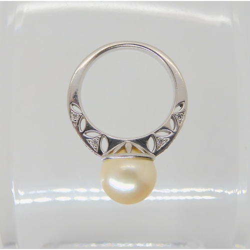 2738 - A PLATINUM PEARL AND DIAMOND RINGwith pretty pierced shank and basket, further set with diamond acce... 