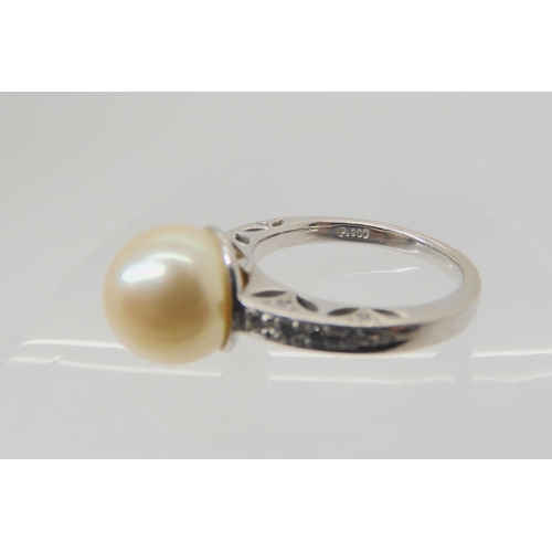 2738 - A PLATINUM PEARL AND DIAMOND RINGwith pretty pierced shank and basket, further set with diamond acce... 