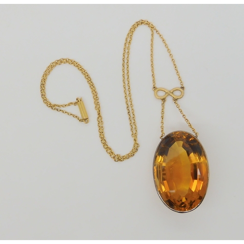2740 - A LARGE CITRINE PENDANT with infinity symbol and chain links. Dimensions of the citrine 2.9cm x 1.9c... 