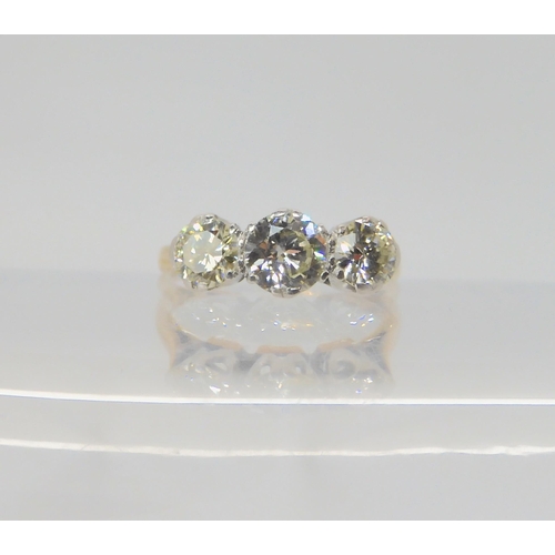 2742 - A THREE STONE DIAMOND RINGthe 18ct and platinum shank is set with estimated approx 1ct of brilliant ... 