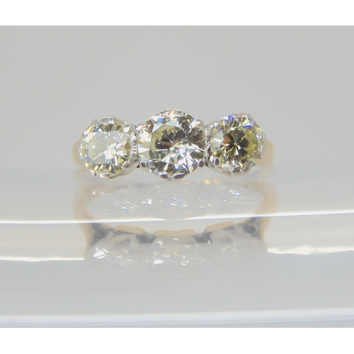 2742 - A THREE STONE DIAMOND RINGthe 18ct and platinum shank is set with estimated approx 1ct of brilliant ... 