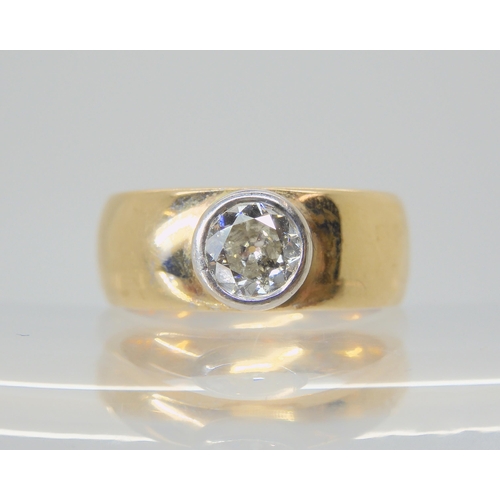 2743 - A DIAMOND SOLITAIREthe wide band ring is stamped 375 and has a bezel set diamond of estimated approx... 