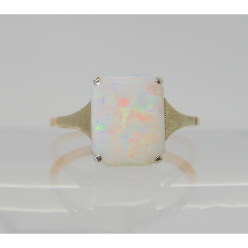 2745 - A VINTAGE WHITE OPAL RINGset with a 10mm x 8.2mm x 1.7mm solid white opal. With white gold shoulders... 
