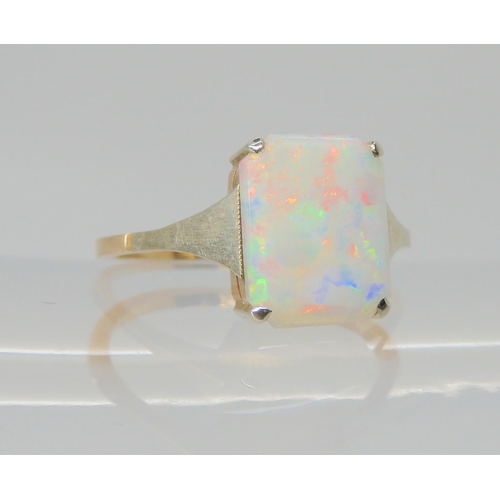 2745 - A VINTAGE WHITE OPAL RINGset with a 10mm x 8.2mm x 1.7mm solid white opal. With white gold shoulders... 