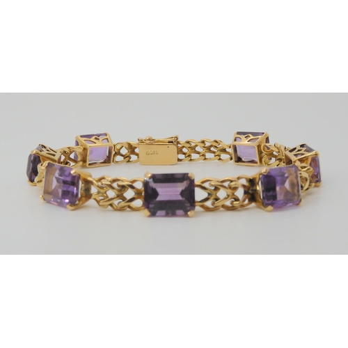 2747 - A FANCY LINK AMETHYST BRACELETthe box clasp stamped 18k, and set with seven step cut amethysts with ... 