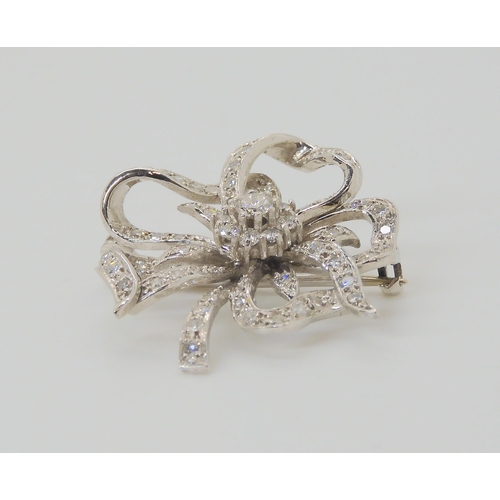 2752 - A DIAMOND FLOWER BROOCHset through out in 18ct white gold, the central diamond is estimated approx 0... 