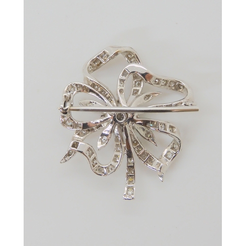 2752 - A DIAMOND FLOWER BROOCHset through out in 18ct white gold, the central diamond is estimated approx 0... 