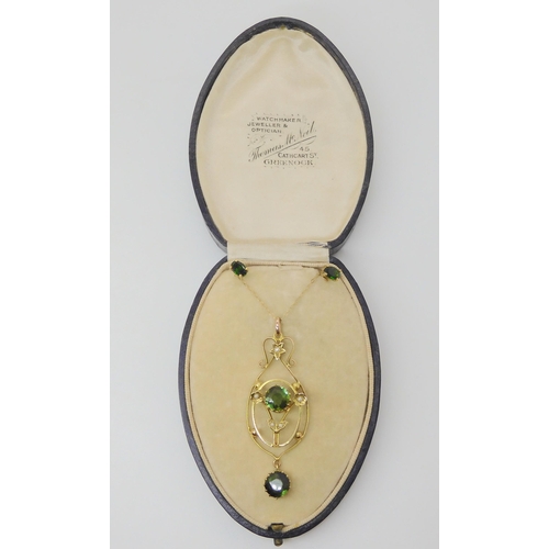 2754 - AN EDWARDIAN PENDANTset with two green tourmalines, of approximate diameter 7.3mm, and seed pearls t... 