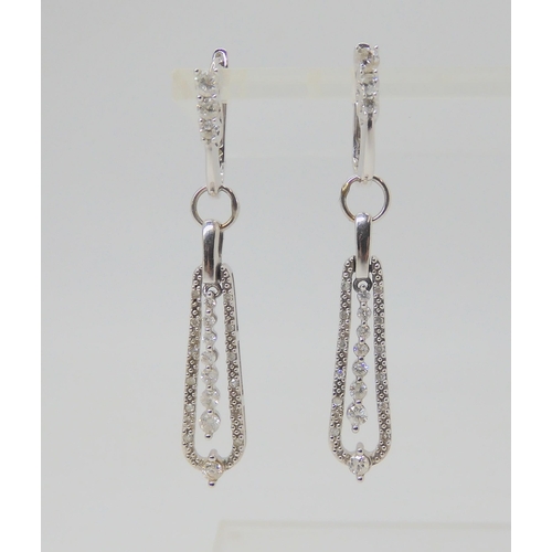 2755 - A PAIR OF DIAMOND DROP EARRINGSmounted in 14k white gold, and set with estimated approx 0.60cts of b... 