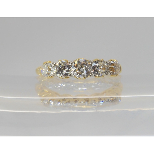 2768 - A FIVE STONE DIAMOND RINGset with estimated approx 0.75cts of old cut diamonds, to a classic scroll ... 