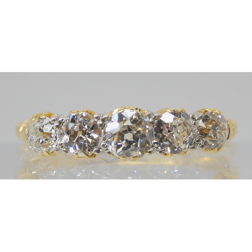 2768 - A FIVE STONE DIAMOND RINGset with estimated approx 0.75cts of old cut diamonds, to a classic scroll ... 