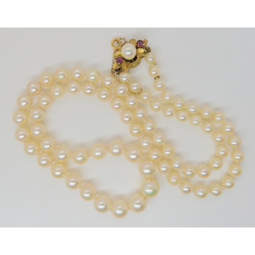 2769 - PEARLS WITH A 14K RUBY AND PEARL CLASPthe light cream coloured pearls with a good lustre, are tapere... 