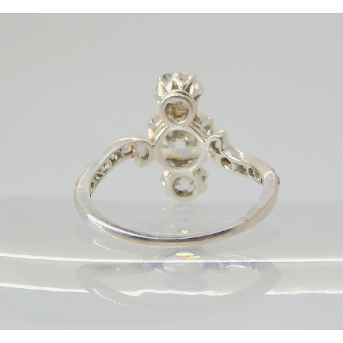 2770 - A VINTAGE THREE STONE DIAMOND RINGthe central old cut is estimated approximately at 0.95cts, with th... 