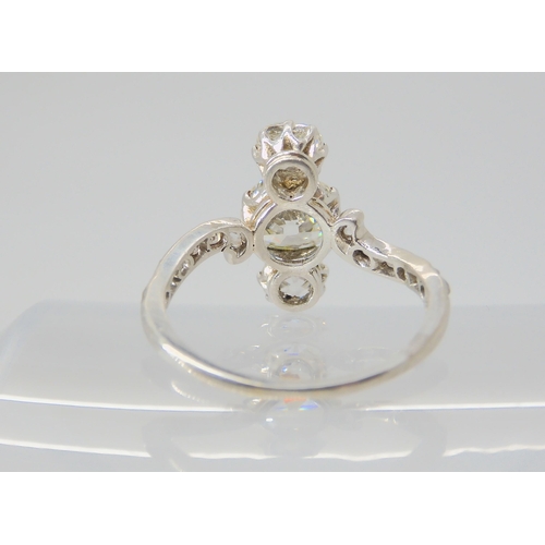 2770 - A VINTAGE THREE STONE DIAMOND RINGthe central old cut is estimated approximately at 0.95cts, with th... 