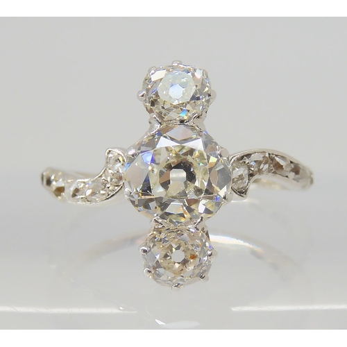 2770 - A VINTAGE THREE STONE DIAMOND RINGthe central old cut is estimated approximately at 0.95cts, with th... 