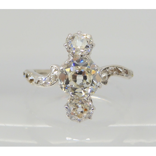 2770 - A VINTAGE THREE STONE DIAMOND RINGthe central old cut is estimated approximately at 0.95cts, with th... 