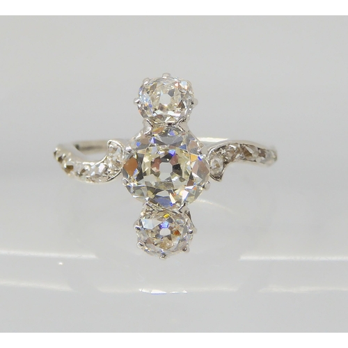 2770 - A VINTAGE THREE STONE DIAMOND RINGthe central old cut is estimated approximately at 0.95cts, with th... 