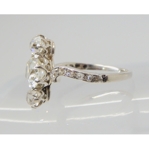 2770 - A VINTAGE THREE STONE DIAMOND RINGthe central old cut is estimated approximately at 0.95cts, with th... 