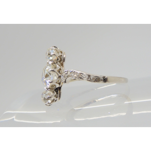 2770 - A VINTAGE THREE STONE DIAMOND RINGthe central old cut is estimated approximately at 0.95cts, with th... 