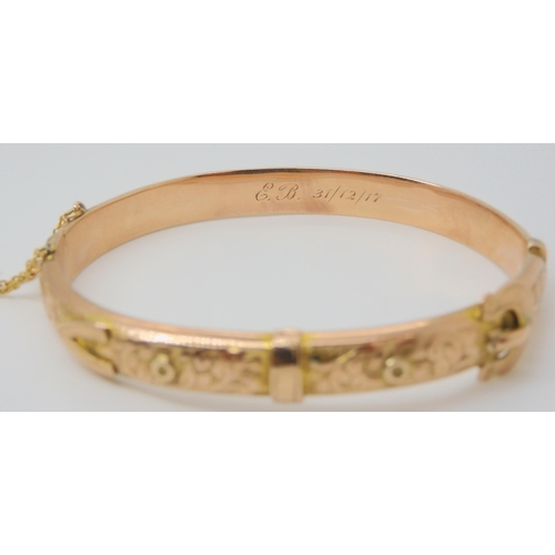 2772 - A 9CT ROSE GOLD BUCKLE SHAPED BANGLEwith floral engraving, hallmarked Birmingham 1916, with inscript... 