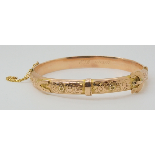 2772 - A 9CT ROSE GOLD BUCKLE SHAPED BANGLEwith floral engraving, hallmarked Birmingham 1916, with inscript... 