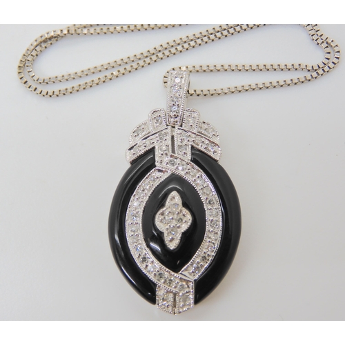 2774 - AN ONYX & DIAMOND PENDANT AND EARRINGSthe pendant stamped 14k, is set with estimated approx 0.50... 