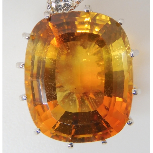 2780 - A CITRINE & DIAMOND PENDANTthe large mixed cut citrine has dimensions of 15mm x 18mm, the pendan... 