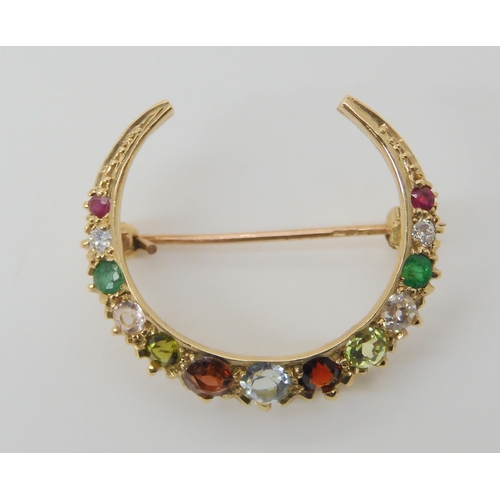 2781 - A CRESENT MOON BROOCHset with gemstones to include rubies, peridot and emerald, diameter 2.6cm, weig... 