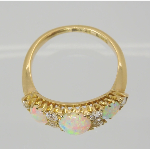 2783 - A VINTAGE OPAL & DIAMOND RINGwith an 18ct gold galleried mount. Largest opal approx 7mm x 5.5mm,... 