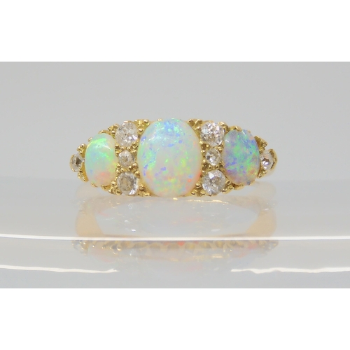 2783 - A VINTAGE OPAL & DIAMOND RINGwith an 18ct gold galleried mount. Largest opal approx 7mm x 5.5mm,... 