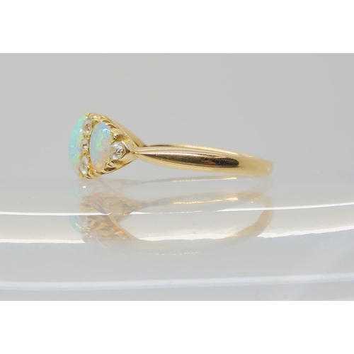 2783 - A VINTAGE OPAL & DIAMOND RINGwith an 18ct gold galleried mount. Largest opal approx 7mm x 5.5mm,... 