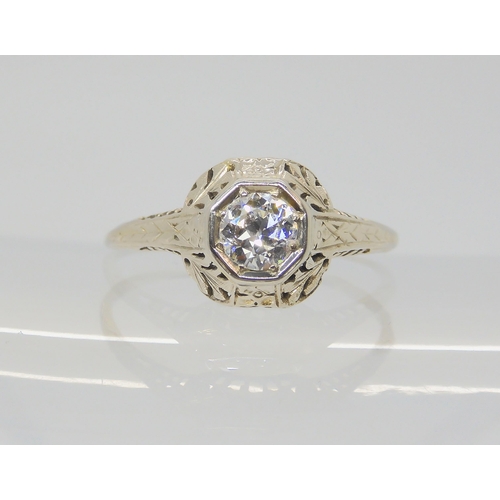 2786 - AN AMERICAN DIAMOND SOLITAIRE RINGwith foliate pierced mount, and engraved shank. Set with an estima... 