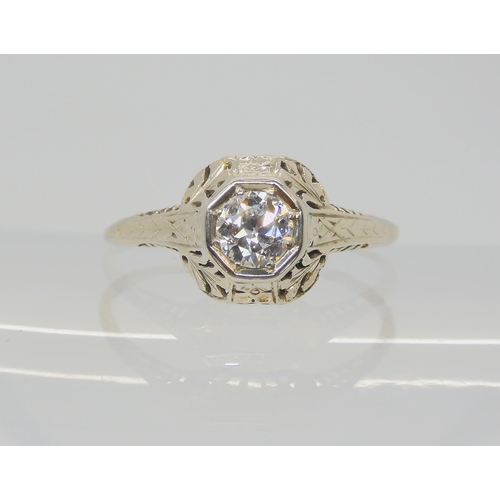 2786 - AN AMERICAN DIAMOND SOLITAIRE RINGwith foliate pierced mount, and engraved shank. Set with an estima... 