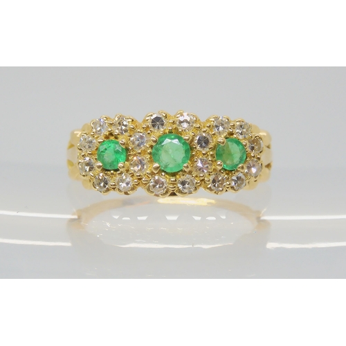 2788 - AN EMERALD & DIAMOND FLOWER CLUSTER RINGset with three emeralds, the largest approx 3.6mm, surro... 