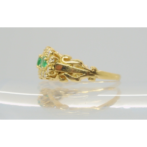 2788 - AN EMERALD & DIAMOND FLOWER CLUSTER RINGset with three emeralds, the largest approx 3.6mm, surro... 