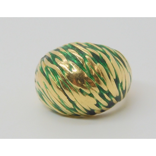 2796 - A KUTCHINSKY ENAMEL RINGthe 18ct yellow gold high domed ring is enamelled in green to the textured g... 