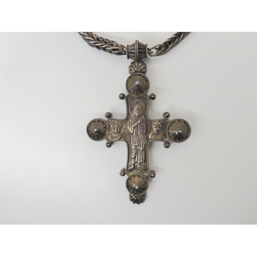 2810 - A LARGE WHITE METAL RELIQUARY CROSSwith hand chased detail to the figures and a handmade loop in loo... 