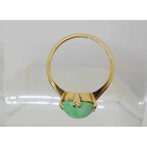 2818 - A CHINESE GREEN HARDSTONE RINGmounted in bright yellow metal, the hardstone measures approx 16mm x 9... 