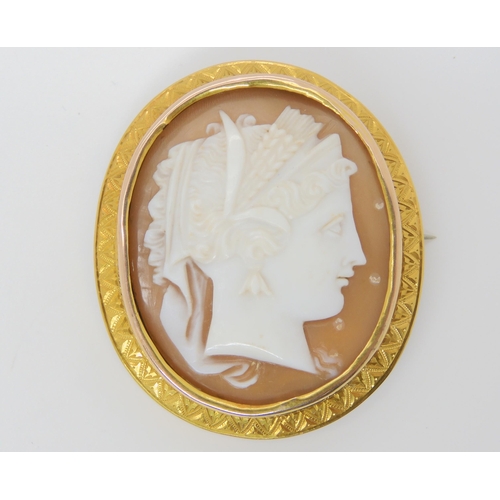 2827 - A WELL CARVED CAMEO BROOCHthe cameo of a maiden set into a bright yellow metal engraved brooch mount... 